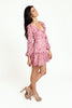 Floral pink mini dress, with a ruffled V-neckline, long lantern sleeves, a full, ruffled hemline and a sexy ruffled lace-up back.